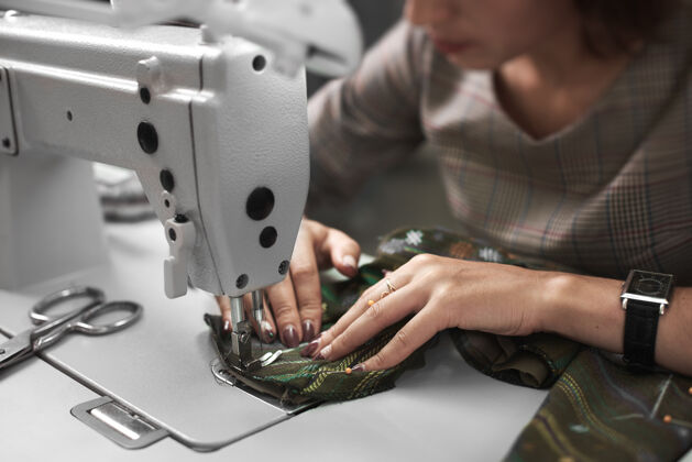 车间在现代电动缝纫机上工作的女裁缝创意机器制造