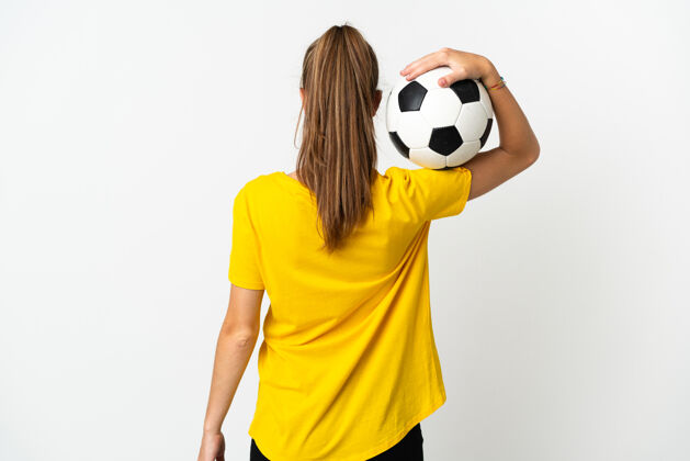 专业年轻的白种女人 拿着足球 被隔离在白色背景下女孩休闲运动员