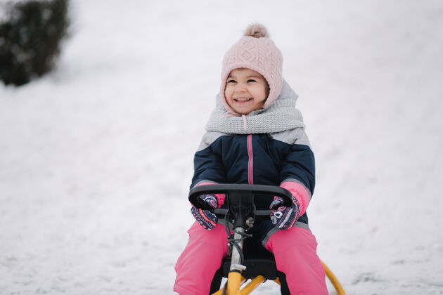 童年小女孩喜欢坐雪橇父母雪白天