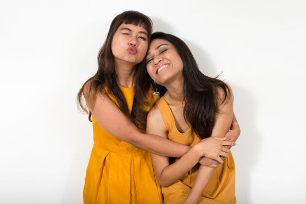 同性恋两个年轻的亚洲女人一起对抗白色空间亲吻女同性恋情侣