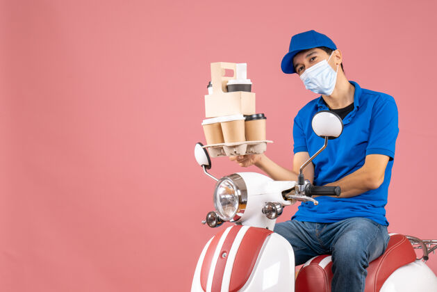 坐俯视图微笑的男性送货员戴着口罩戴着帽子坐在滑板车上送桃子的订单卡通桃自动装置