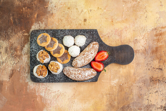 食品俯瞰木制桌子上美味的甜点和饼干顶部种子棕色