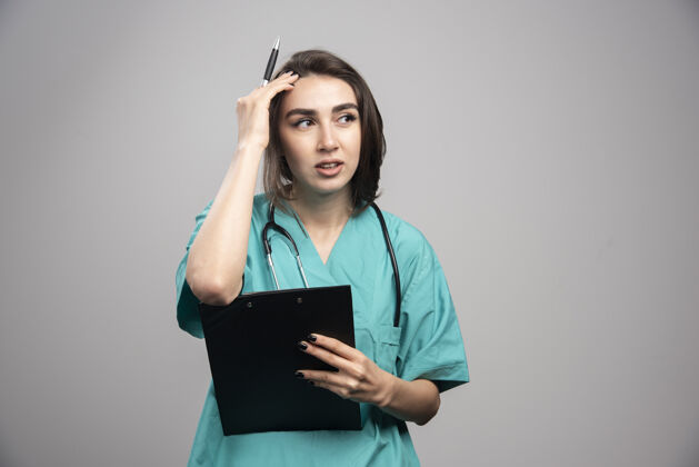 妇女女医生头痛的灰色背景高质量的照片治疗医生检查