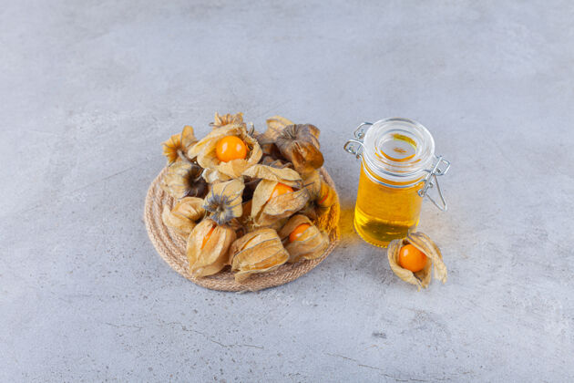 健康健康的金橘干果和蜂蜜放在石桌上可口水果金橘