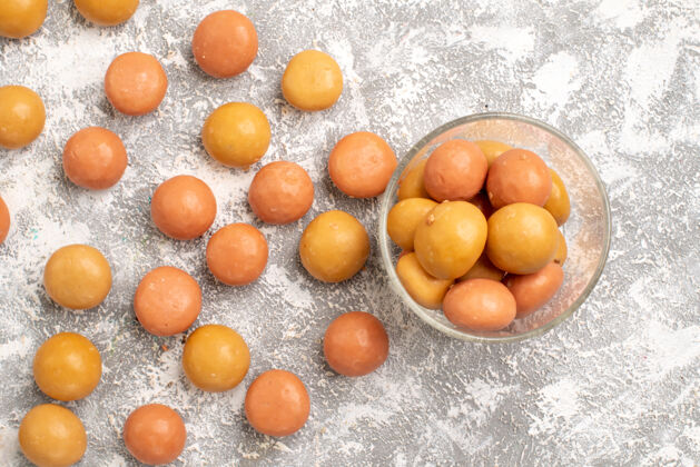 健康白色表面糖果的俯视图橘子新鲜杏子