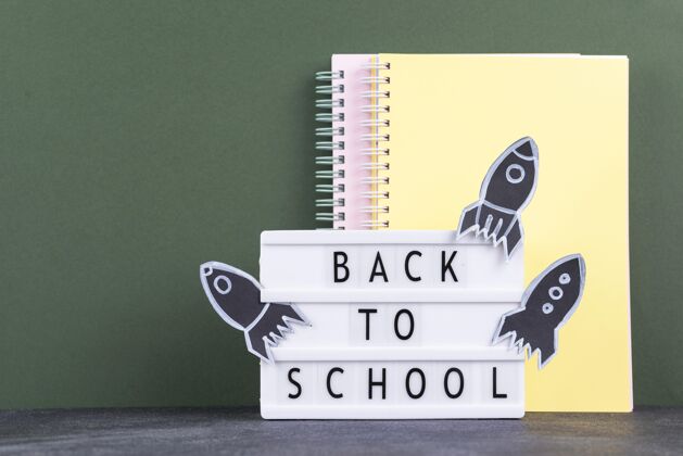 标志带着笔记本和灯箱回到学校背景返校学校用品背景