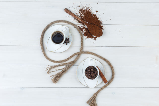 粗麻布顶视图咖啡杯与研磨咖啡 香料 咖啡豆 木制背景绳水平新鲜早餐