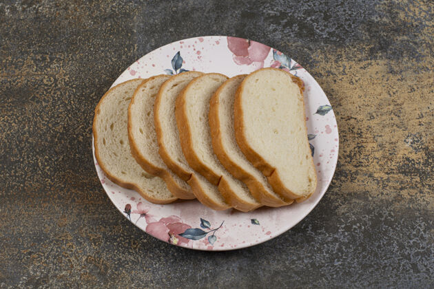 一餐美味的白面包片放在五颜六色的盘子里有机美味切片