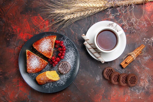碗俯瞰美味的切片派饼干和一杯茶在黑暗的桌子上甜甜的派蛋糕饼干杯子