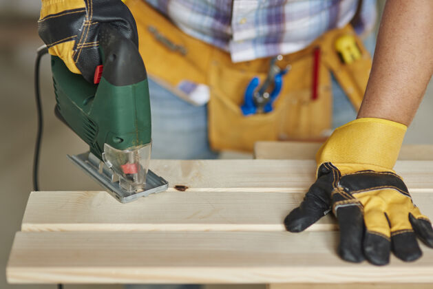 手握特写有经验的木匠钻木板木匠人创造