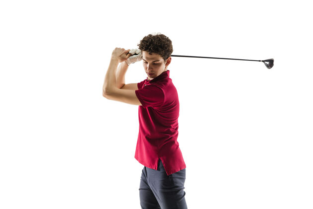 男子穿红衫的高尔夫运动员在白色的工作室里荡秋千球场年轻打球