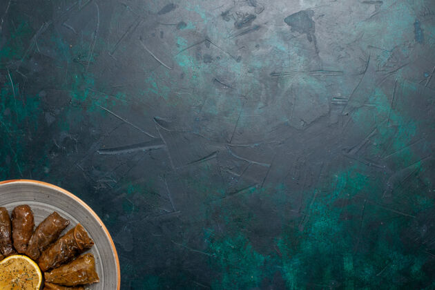 叶子俯瞰叶多尔玛美味的东方肉食卷里边绿叶深蓝色书桌上的肉食晚餐蔬菜健康卡路里视图内部卷