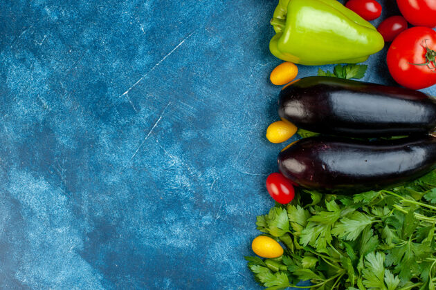 各种蔬菜顶视图各种蔬菜樱桃西红柿甜椒莳萝茄子欧芹在蓝色桌子的右边复制的地方樱桃地方番茄