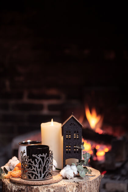 舒适静物画 热饮 蜡烛和装饰在熊熊燃烧的火堆上晚上在壁炉旁放松的概念树树桩温暖