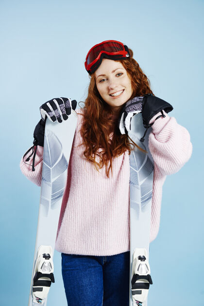 护目镜带着滑雪板的快乐女人的画像滑雪者运动设备配件
