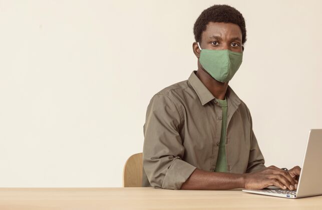 笔记本电脑使用笔记本电脑和戴绿色医用面罩的人数字摄影非洲