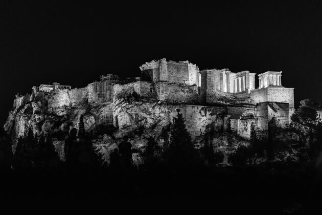 日落灰阶的奥林匹亚宙斯神庙下的灯光在夜晚被树木环绕旅游城市遗址