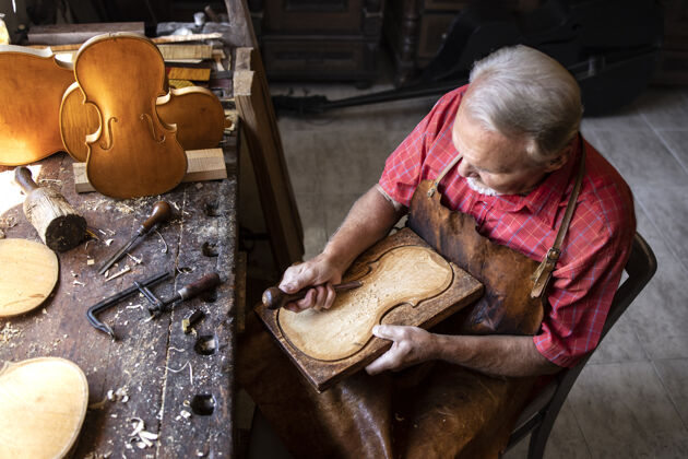 手工高级木匠在旧时装工作室工作的顶视图产品年份木工