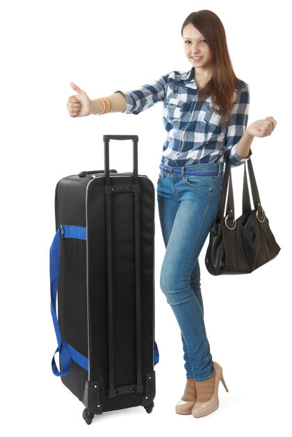 行李16岁的小女孩 带着黑色的大旅行包女性女士通过