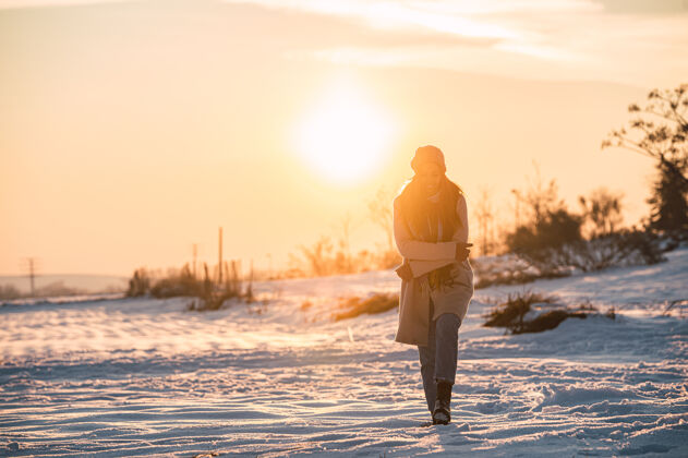 天气夕阳时分 冬日乡间 一身暖洋洋的快乐少女 在新鲜的白雪上漫步内容寒冷时尚