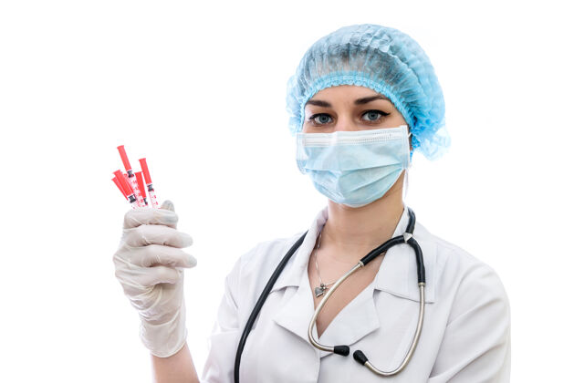 保护交上医用手套 把注射器隔离在白墙上设备医学护士