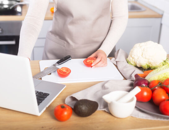 蔬菜女厨师根据在线班的教程健康电脑素食者