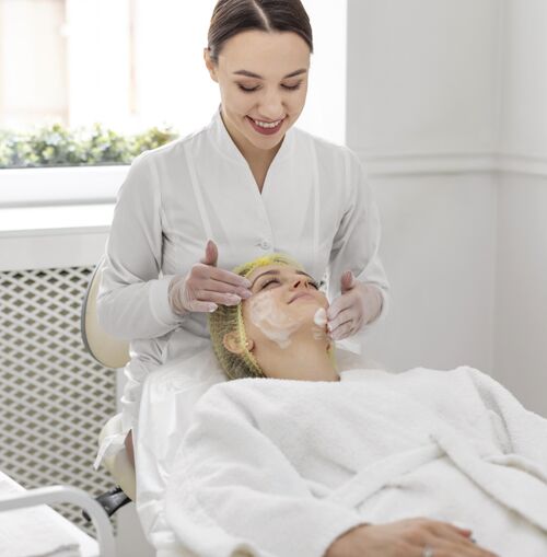 治疗在美容诊所做面部护理的女人美容常规面部治疗美容院