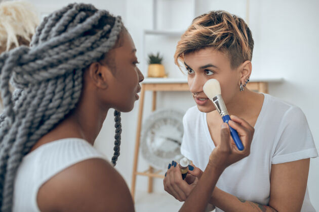 化妆品制造上非洲美国女孩在和女朋友化妆美容师夫妇同性恋夫妇