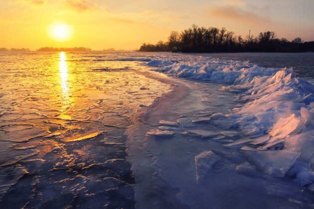 雪日出和冰冻大海美丽冬天的风景 早晨的湖光山色日出芦苇场景