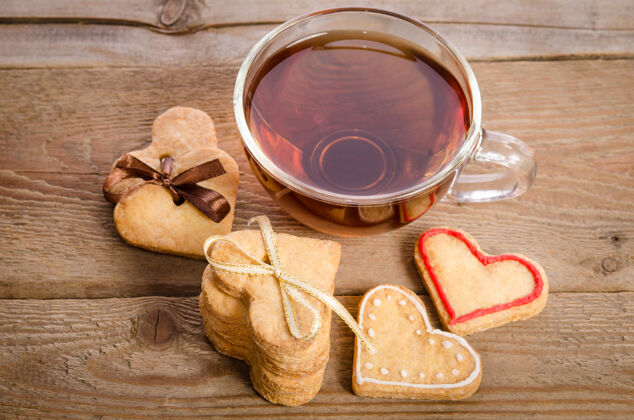 心饼干和一杯茶放在木头上茶自制情人节