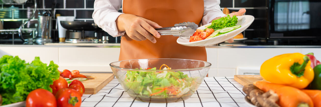 室内女人在准备健康食品蔬菜沙拉的过程中有机家庭主妇生活方式