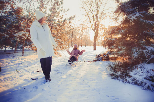妈妈妈妈和女儿在冬季公园玩得很开心孩子幼儿女人