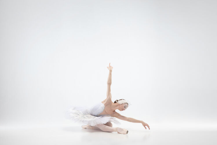 艺术家以白色工作室为背景的年轻优雅的芭蕾舞演员移动优雅人