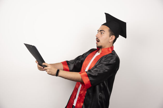 满意年轻的研究生把他的毕业证书涂在白色上证书惊喜男性