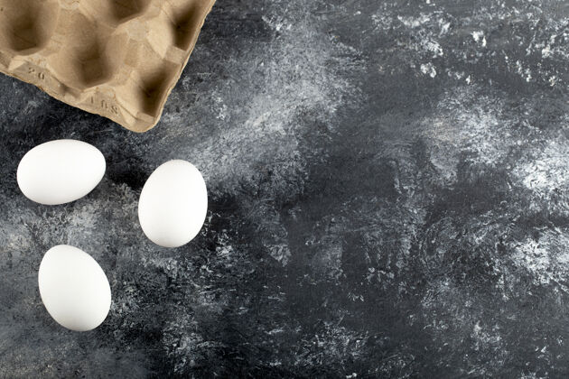 农产品三个生鸡蛋放在大理石表面上蛋白质鸟类烹饪