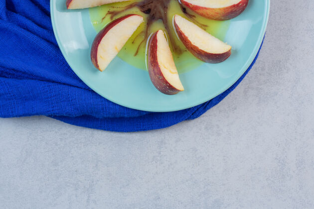 种子把红黄苹果片放在蓝盘子里明亮营养健康
