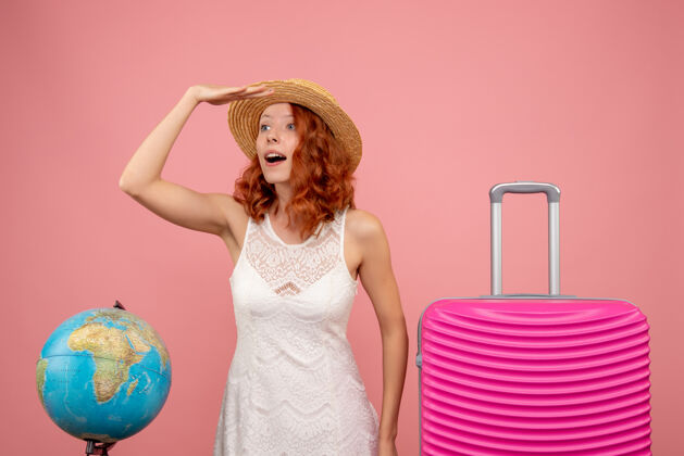 美丽年轻女性游客的正面图 粉红色的墙上挂着粉红色的包航行人模型
