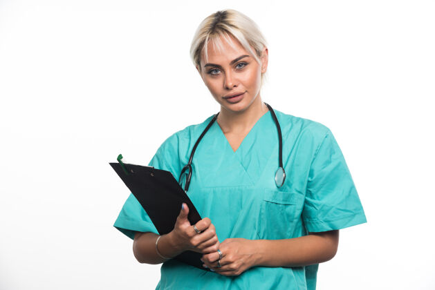 听诊器女医生用听诊器把剪贴板放在白色的表面上医生护理女士