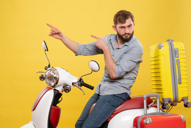 人旅游概念与年轻的情感胡须男子坐在摩托车上指着黄色摩托车向上微笑