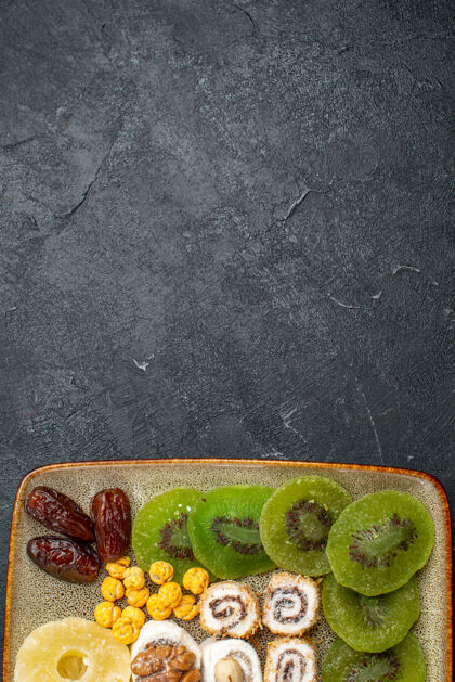 健康顶视图切片干果菠萝戒指和猕猴桃灰桌干果葡萄干甜酸维生素健的新鲜桌子