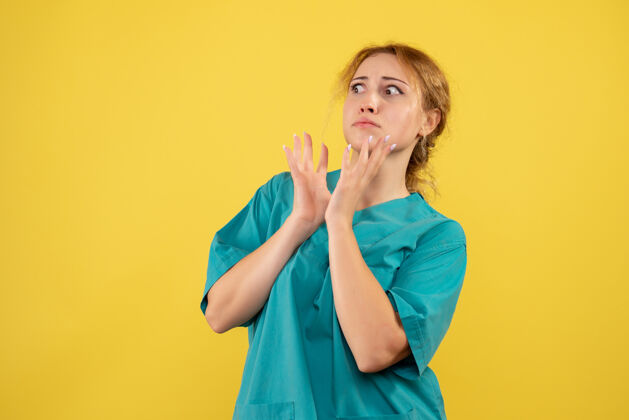 肖像正面图黄色办公桌上穿着医疗衬衫的女医生covid-19护士颜色健康医疗人女性健康