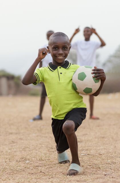 足球一个拿着足球的非洲小孩足球比赛孩子玩