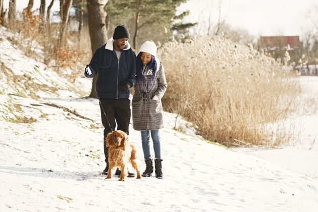 感情人们在外面散步冬天非洲夫妇带着狗霜冻白天森林