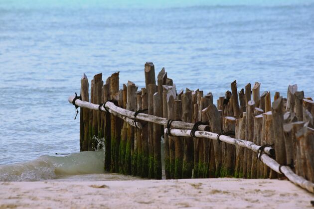 板近景垂直木板的一个未完成的码头在海滩上被大海包围湖日旅游