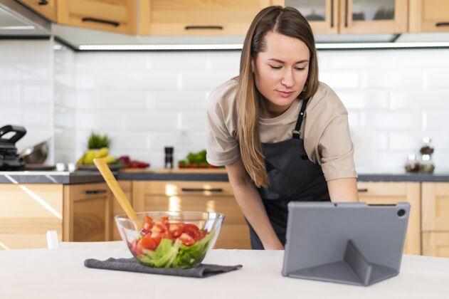 烹饪中枪女人在看平板电脑水平美味分类