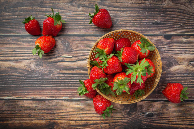 成熟新鲜草莓放在木桌上的碗里营养乡村节