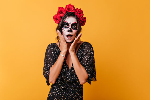 拉丁语情绪激动的墨西哥黑发女子头上戴着鲜花 用手抚摸着自己震惊的脸恐怖恐怖幻想