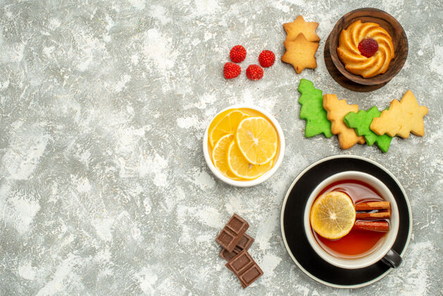 饼干顶视图杯茶饼干和柠檬片在碗圣诞树饼干在灰色表面自由空间茶杯花玫瑰