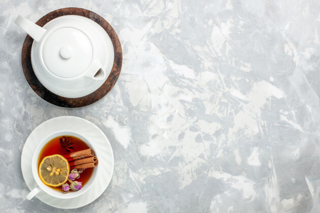 瓷器顶视图一杯茶 柠檬和肉桂在浅白色的表面盘子瓷器垃圾