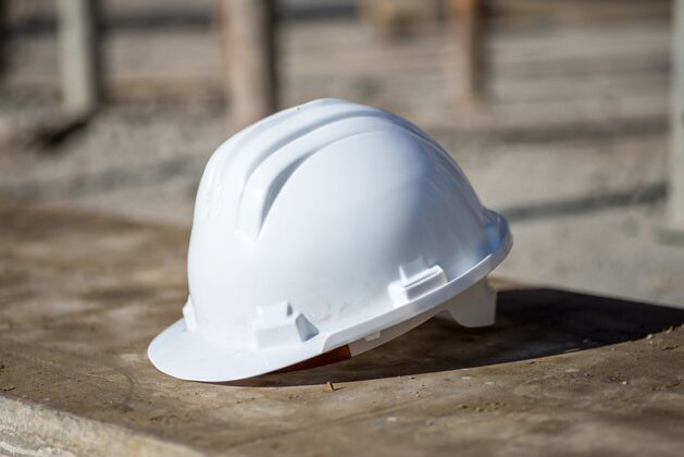 安全帽白色建筑头盔在阳光下趴在地上承包商建筑工程师